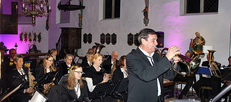 Martin Korte mit Trompete vor großem Blasorchester